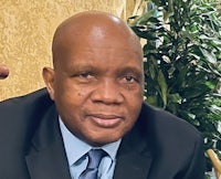 a man in a suit and tie sitting at a table